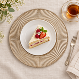 Antique silver radiant charger beneath a separate white dessert plate, with tea alongside