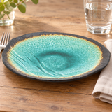 Turquoise and aqua irregular ceramic plate in a fork water-glass and linen place setting