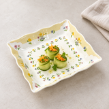 One plate from the FP-09 four-piece yellow floral set with cucumber appetizers