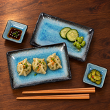 Blue plate and dish set with dumplings and vegetables