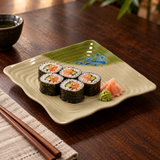 Sushi rolls on the 11-inch beige and green wavy square melamine plate