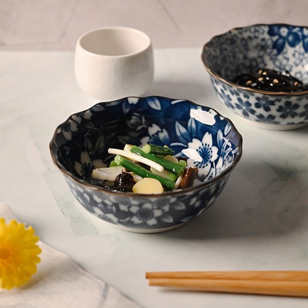 Serving suggestion with vegetables in the dark blue sakura bowl, with a white cup, chopsticks and the lighter patterned companion nearby.