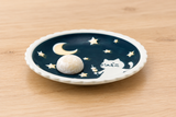 Moonlit cat scalloped plate with one petite mochi on a wooden table