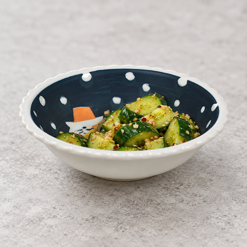 Sesame cucumber side dish in the shallow navy-and-white HB544-NH cat bowl.