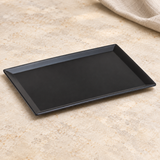 Black rectangular plate in a natural tabletop setting