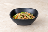 Black square bowl with soba and vegetables