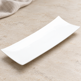 Long white rectangular plate in a natural tabletop setting