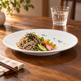 J812C-HM Rain Flower round plate with soba noodles and vegetables on a wood dining table