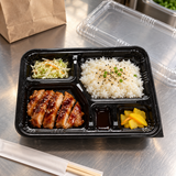 J-8306-2 five-compartment bento tray with a prepared meal on a restaurant packing counter