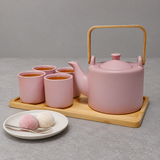 JHS6-BG tea set with four filled cups and a separate plate of two mochi sweets and a fork.