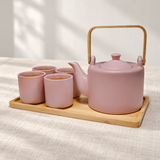 JHS6-BG tea set with tea in four cups on its tray, shown on a linen table.