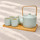 JHS6-GR tea set with tea in four cups on its tray, shown on a linen table.