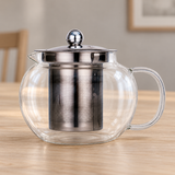 JN63G-2 glass teapot with metal lid and infuser on a dining table