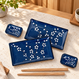 JX79-AP sushi plate and dish set with two chopstick pairs on a restaurant counter