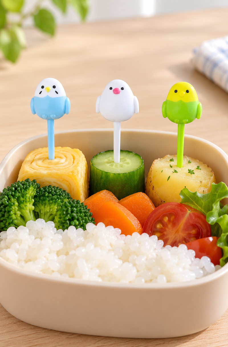 Three small bird food picks inserted by their stems into bite-size lunch portions