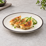Ivory grooved dark-rim plate with three dumplings