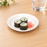 K382-1 white round plastic plate with cucumber sushi