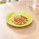 K382-2 green round plastic plate with gyoza