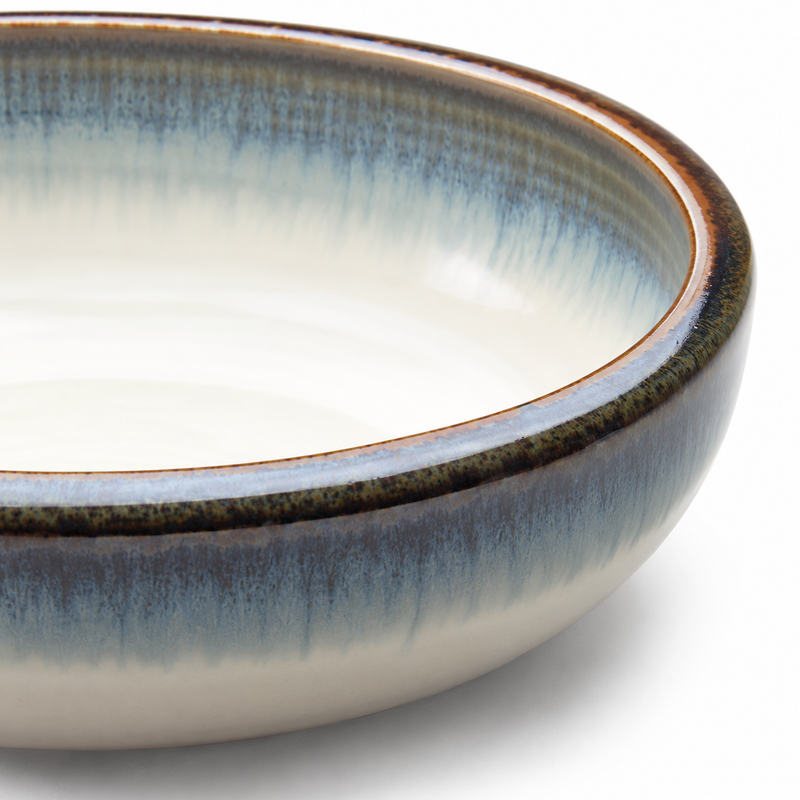 Close view of the K59-A bowl’s blue-grey gradient, pale center and dark warm-edged rim