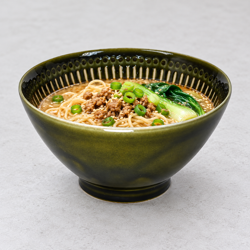 Serving suggestion with noodles, minced topping and green vegetables in the Oribe green bowl.