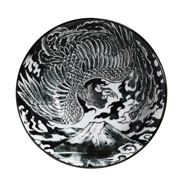 Overhead view of the black phoenix bowl showing detailed feathers, cloud forms and a mountain across the interior.