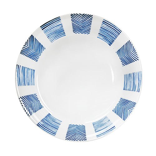 Overhead view of the white shallow bowl with alternating blue chevron and parallel-line blocks around its inner rim.