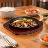 NTP-03 round iron steak plate with wood base — sliced beef serving suggestion