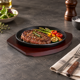 NTP-03 round iron steak plate with wood base — steak and vegetables serving suggestion
