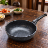 Marble-coated wok pan on a restaurant table