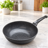 Marble-coated wok pan on a restaurant counter