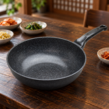Marble-coated wok pan on a restaurant table