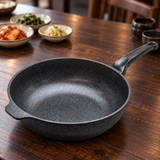 Marble-coated wok pan on a restaurant table