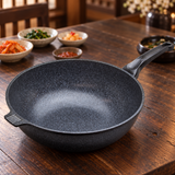 Marble-coated wok pan on a restaurant table