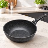 Marble-coated wok pan on a restaurant counter