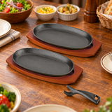 HB-3026 two oval iron steak plates with two wooden bases and separate holder — table setting