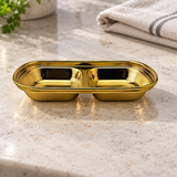 ssg-sap2-6 gold divided sauce dish on a restaurant counter