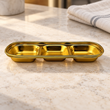 ssg-sap3-8 gold divided sauce dish on a restaurant counter