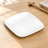 White square side dish on a dining table