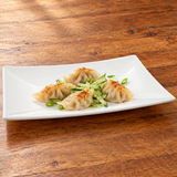 M0879 white rectangular plate with dumplings and cucumber