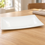White rectangular melamine plate in a natural tabletop setting