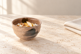M543-C: Yogurt with pear and walnuts on warm ivory stone.