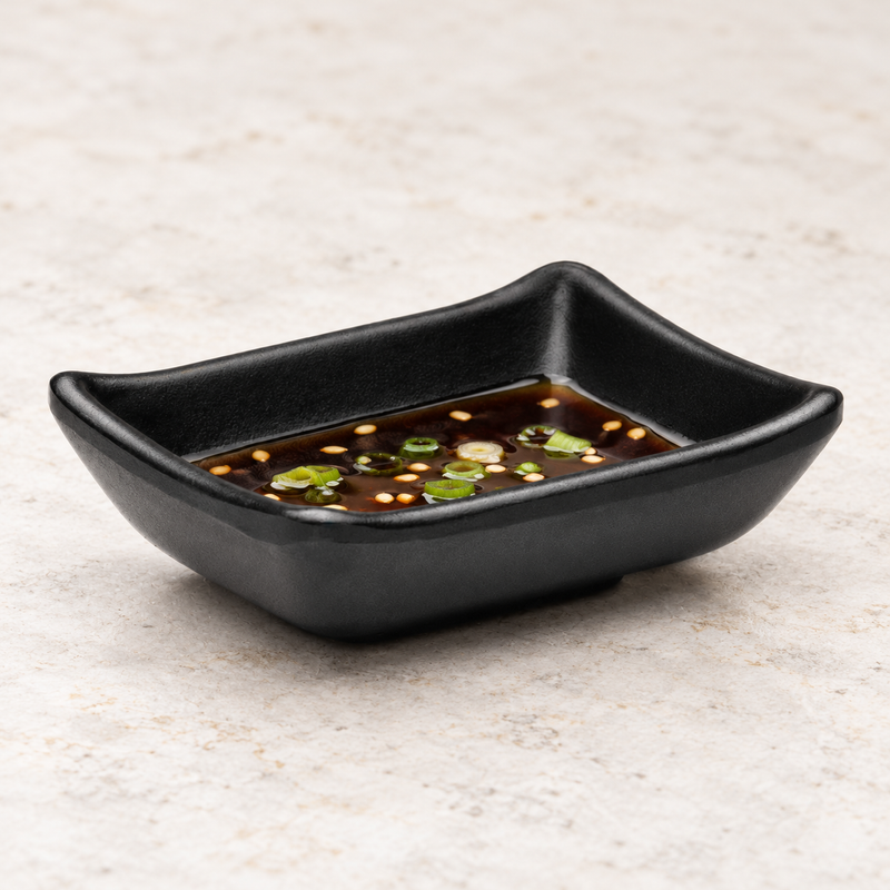 YG-310MB matte black single-well sauce dish with soy sauce and scallions.