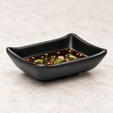 YG-310MB: Melamine Rectangular Sauce Dish 3-3/8", Matte Black. Restaurant serving context