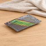 Green and charcoal rectangular ceramic plate in a natural tabletop setting