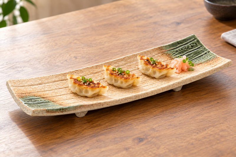 MK212-BR brown ceramic serving plate with three gyoza on a wood table