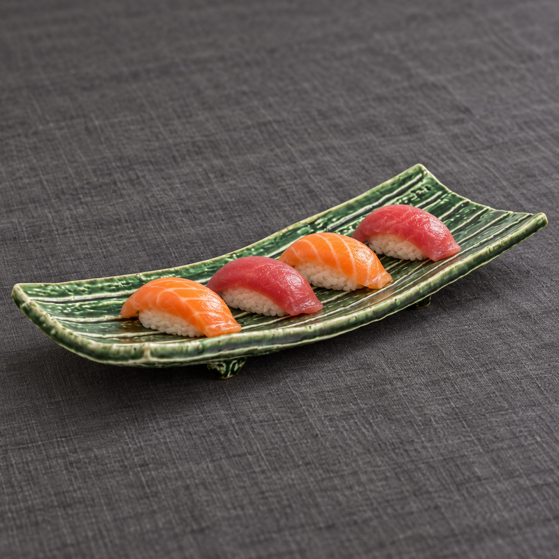Narrow green ridged ceramic plate with four nigiri sushi pieces