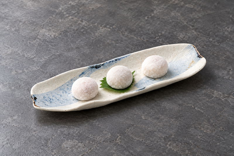 Beige and pale blue curved platter with three mochi sweets