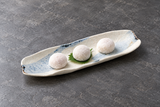 Beige and pale blue curved platter with three mochi sweets