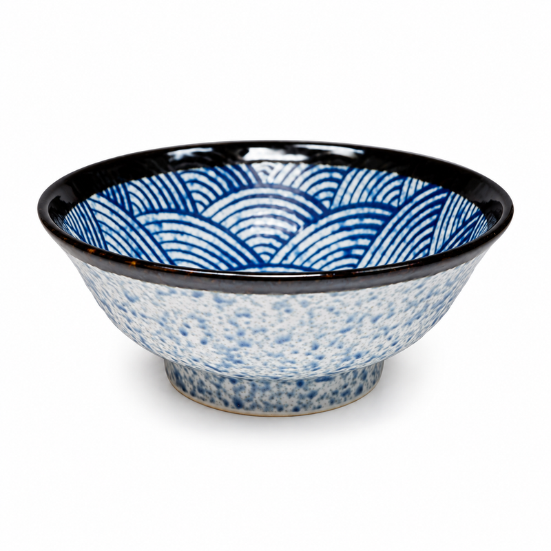 Empty MS-2601 ceramic bowl with blue nested-wave interior motifs, a dark rim, pale blue mottled exterior and a short foot on white.