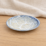 Blue and beige ceramic dish in a natural tabletop setting
